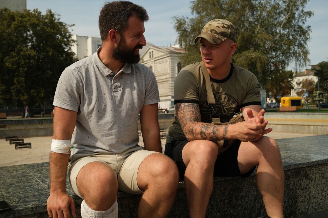 Dmytro (right), the commander of Ukraine's “Nightingale” battalion, visits Vasyl, a member of the battalion who was wounded in Russia.