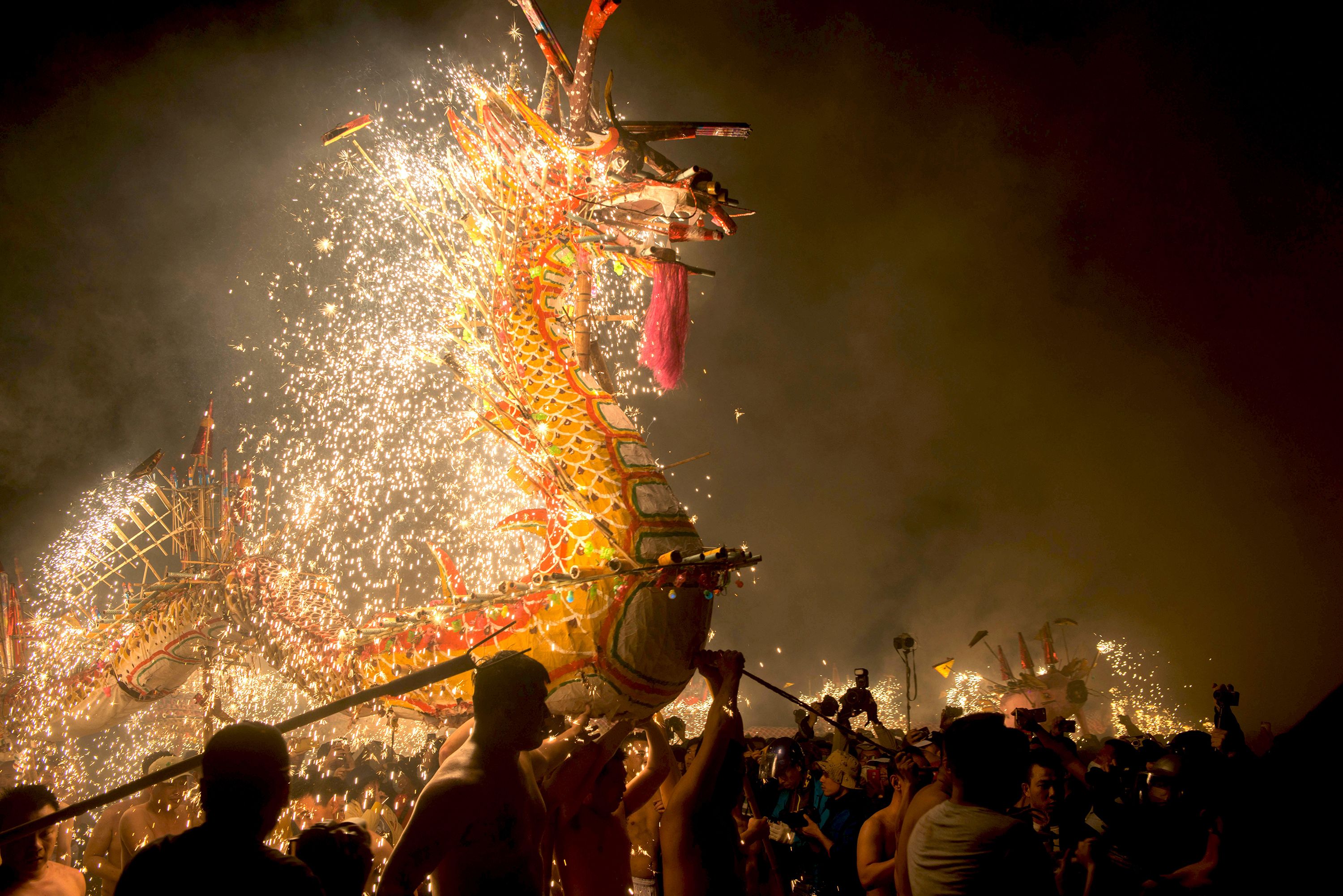 Entertainers perform a fire dragon dance to celebrate the Lantern Festival in Puzhai town, in China's Guangdong province.