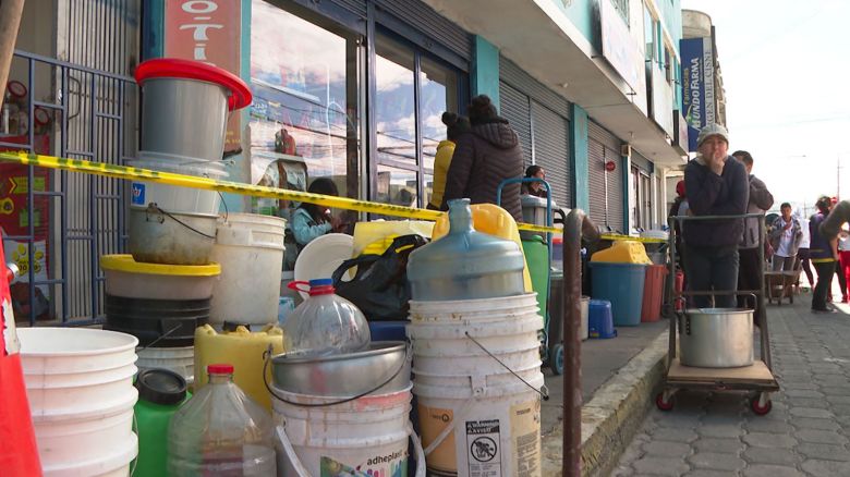 People in Quito, Ecuador, wait for a tanker to deliver water.