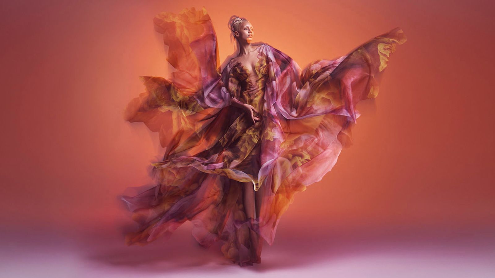 The translucent, layered "Cosmica" dress featuring clouds of color was created in collaboration with artist and former NASA engineer Kim Keever. 