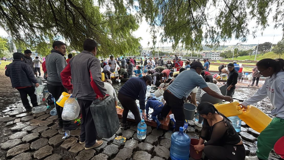 People in Quito, Ecuador, gather water from a nearby spring.