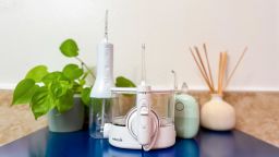 Waterpik water flosser in the center and in front of two other water picks.