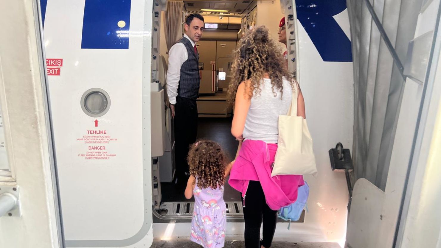 Ivan Watson's wife and daughter board a Turkish Airlines flight from Beirut Rafik al Hariri Airport on Sunday after cutting short a visit to Lebanon due to escalating tensions.