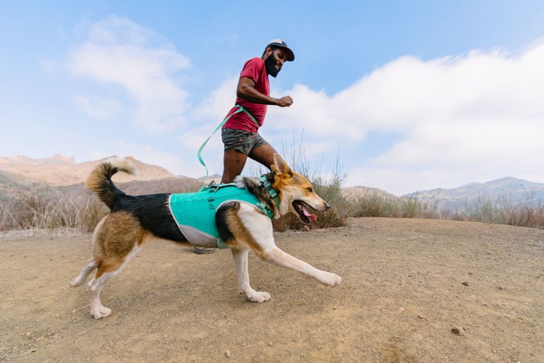 Batman the dog and his human in the Backbone Trail of the Santa Monica Mountains. Batman wears a Ruffwear Swamp Cooler Zip Vest and apparel.