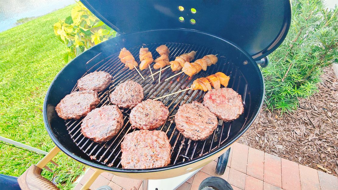 Weber Kettle grill with burgers and skewers