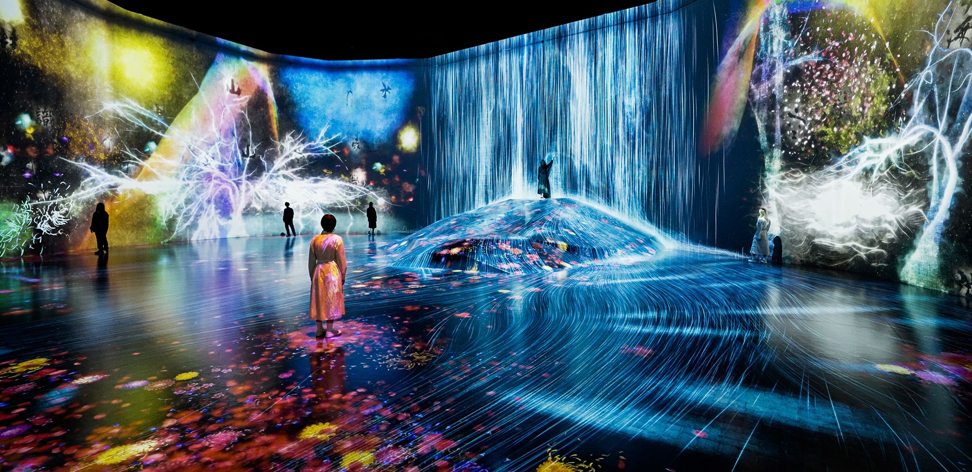 A work entitled "What a Loving, and Beautiful World" appears to move and spread through the room at teamLab's new museum space.