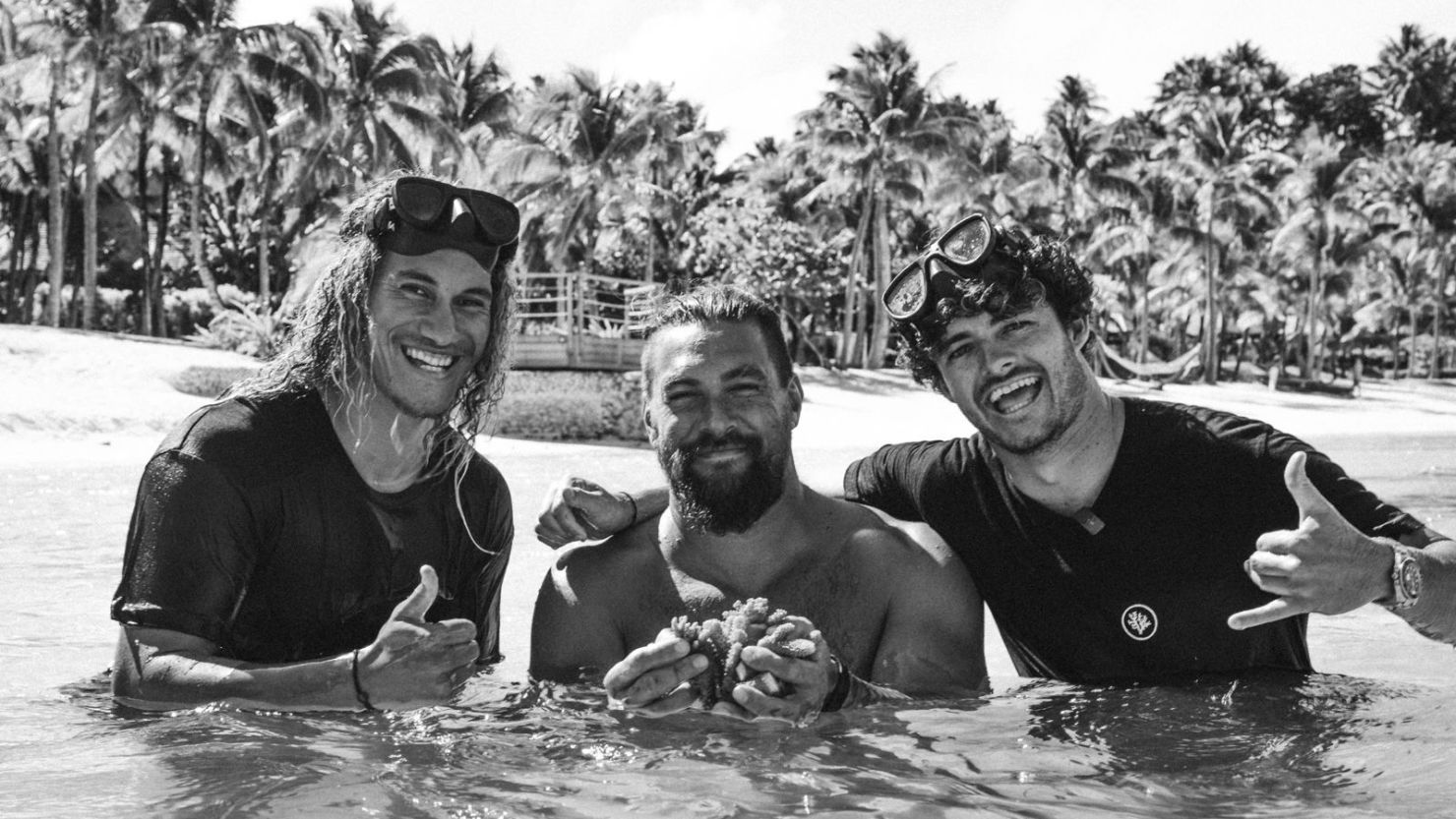 Actor Jason Momoa (center), who stars as "Aquaman," poses with Coral Gardeners member Taiano Teiho (left) and founder Titouan Bernicot (right).
