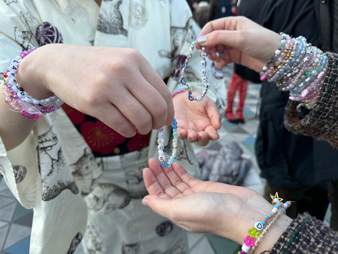 Fans exchange personalized friendship bracelets ahead of Taylor Swift's concert in Tokyo, Japan, on February 7, 2024.