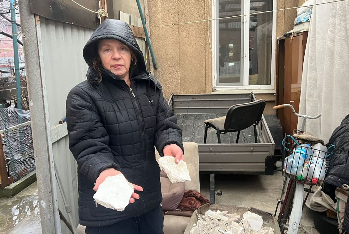 Maria Slisovka stands outside her house near the missile strike in Odesa.