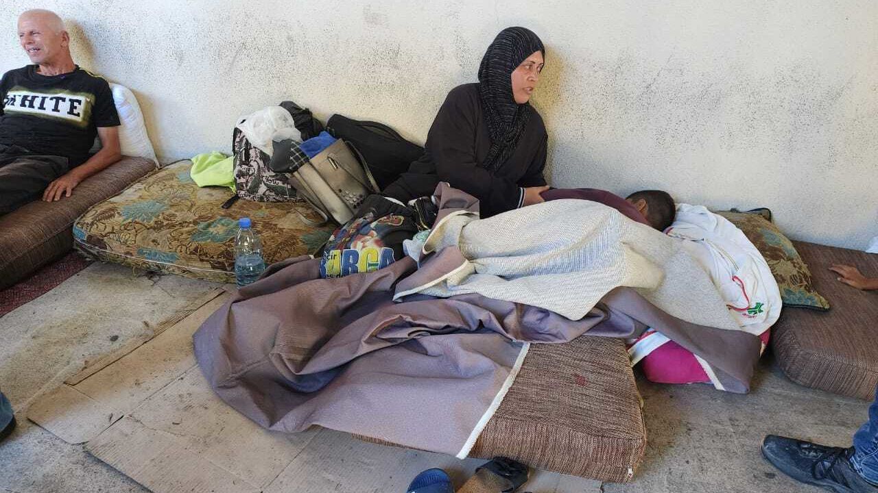 Om Mohammed feeds her 10-year-old son medicine in Sidon, Lebanon, on September 26.