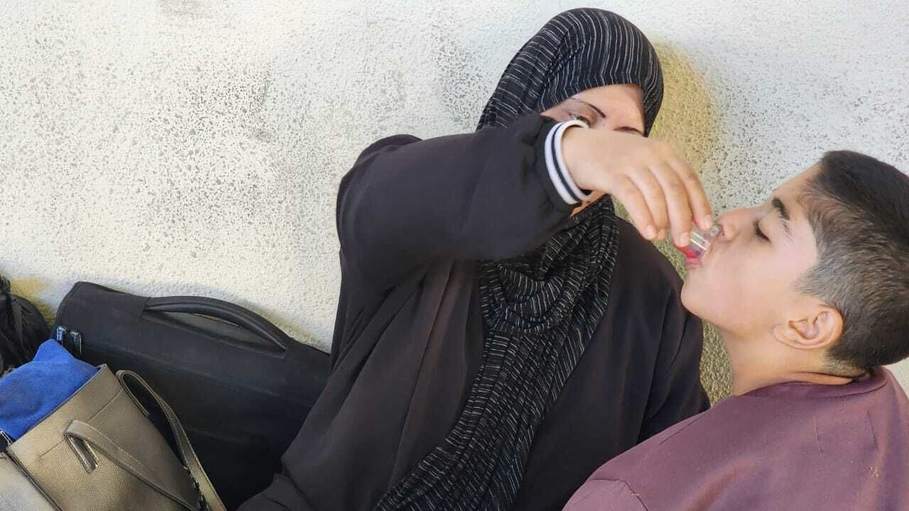 Om Mohammed feeds her 10-year-old son medicine in Sidon, Lebanon.