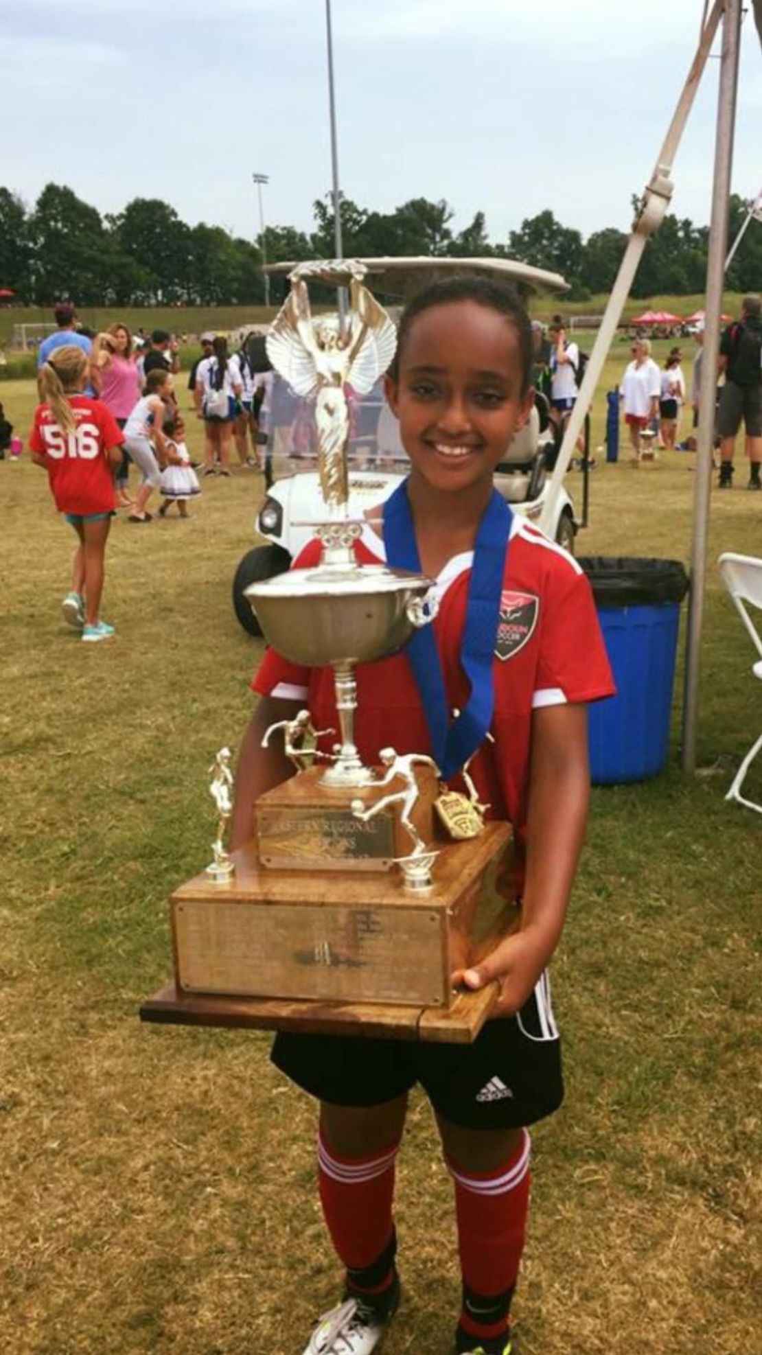 Lily Yohannes holding a trophy she won playing for Loudoun County FC's under-12 team. 