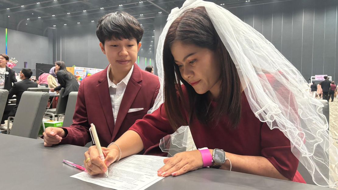 A couple signs their marriage papers in Bangkok.