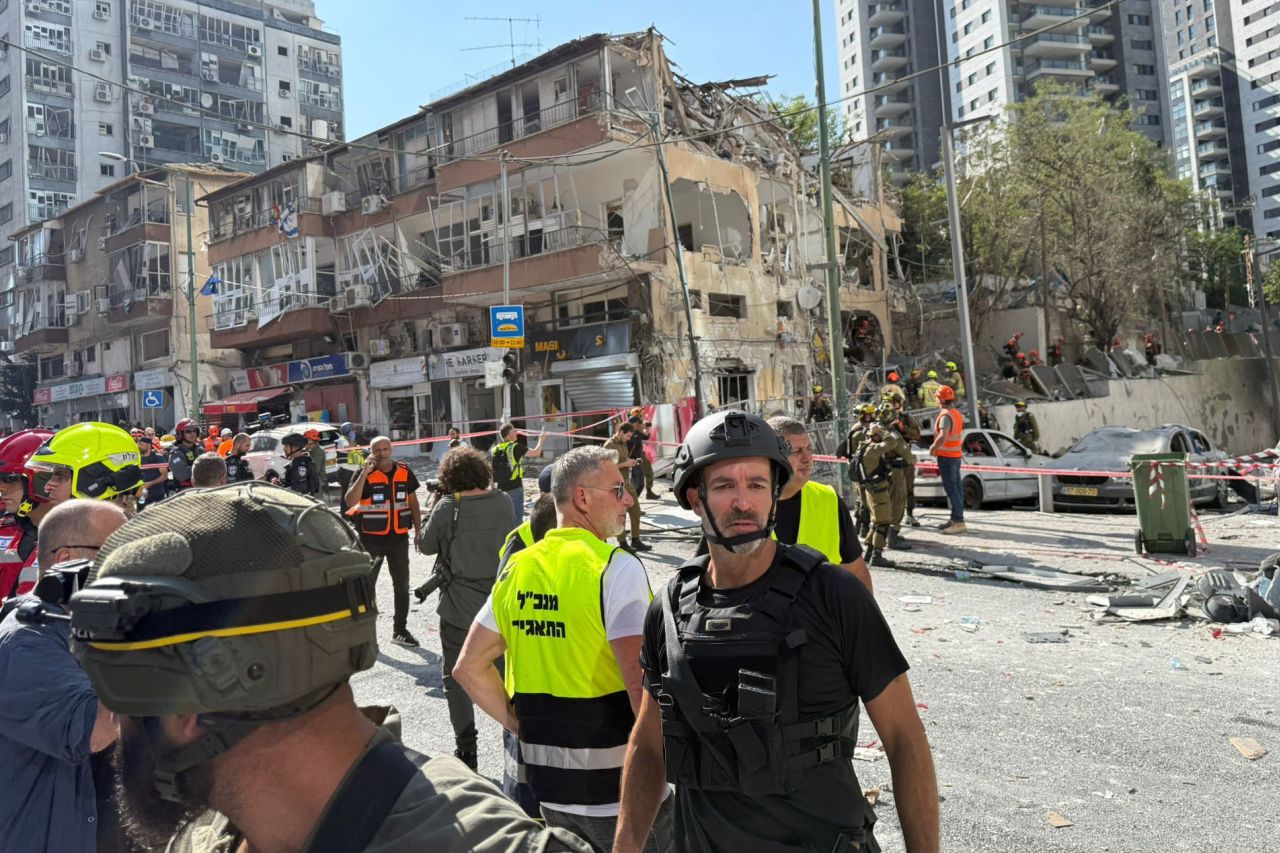 Rescue workers inspect the site of an Iranian missile strike in Ramat Gan, Israel, on Thursday.