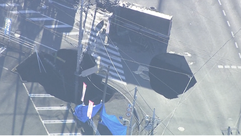 Watch: Sinkhole in Japan swallows sign during rescue mission | CNN