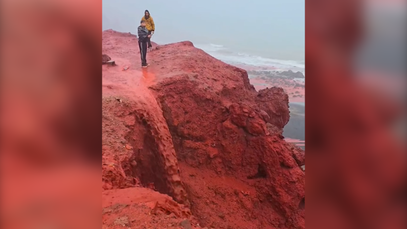 Video: Red rainwater flows down Iranian mountain