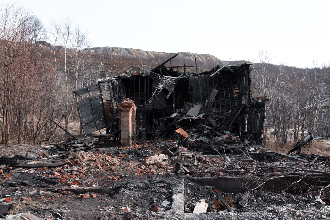An old, wooden damaged burned-down house