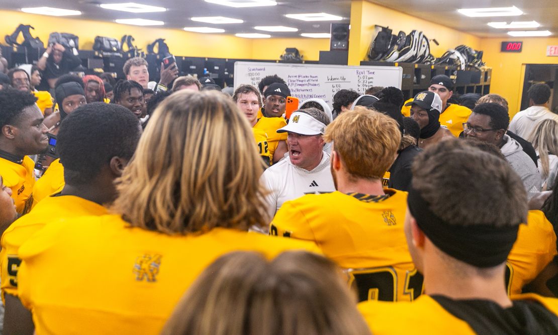 Owls head coach Brian Bohannon addresses players in the locker room after the historic win against the Liberty Flames.