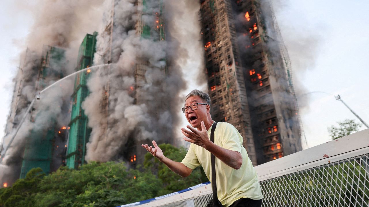 Wong 71, reacts after claiming his wife is trapped inside Wang Fuk Court during a major fire, in Tai Po, Hong Kong, China, November 26, 2025. REUTERS/Tyrone Siu   TPX IMAGES OF THE DAY     