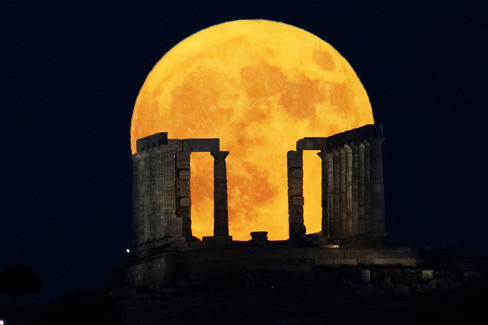 <a >A super blue moon</a> rises behind the Temple of Poseidon at Cape Sounion, south of Athens, Greece, on Monday, August 19. A super blue moon is a <a >rare cosmic combination</a> of a supermoon and a blue moon. The last time this lunar event occurred was August 2023.