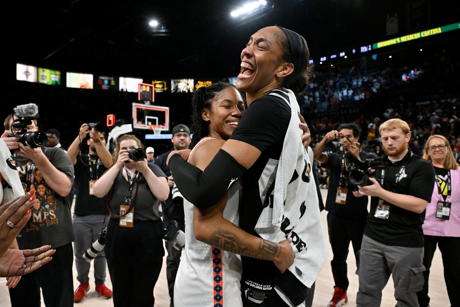 Las Vegas Aces star A’ja Wilson, right, is embraced by Connecticut’s Tyasha Harris, a former college teammate, after Wilson became <a >the first WNBA player to score 1,000 points in a single season</a> on Sunday, September 15. A couple of days later, <a >Wilson broke the league’s single-season rebound record as well</a>.