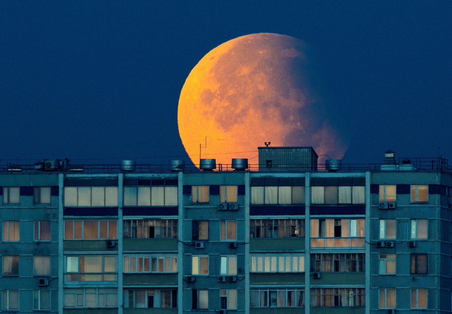 A partial lunar eclipse is seen over a residential building in Moscow on Wednesday, September 18. Sky-gazers around the world <a >were able to glimpse the eclipse</a> while September’s harvest supermoon was shining brightly.