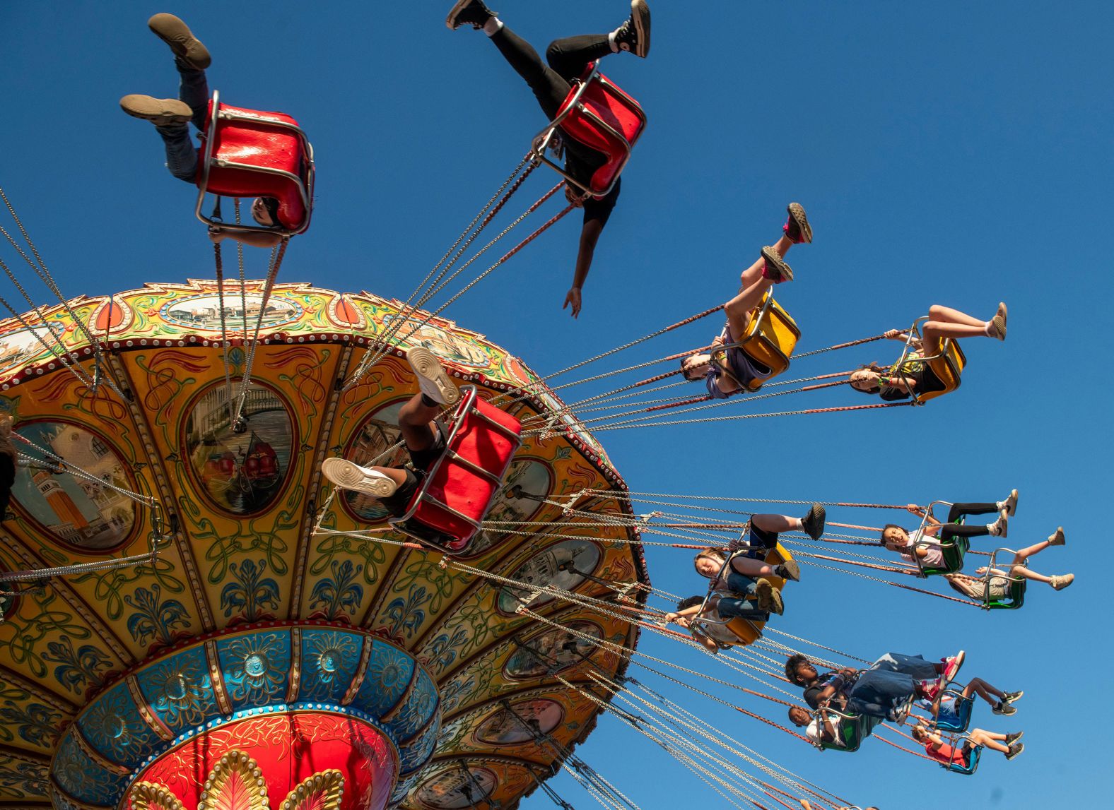 People enjoy a ride at the Pensacola Interstate Fair in Pensacola, Florida, on Sunday, October 20.