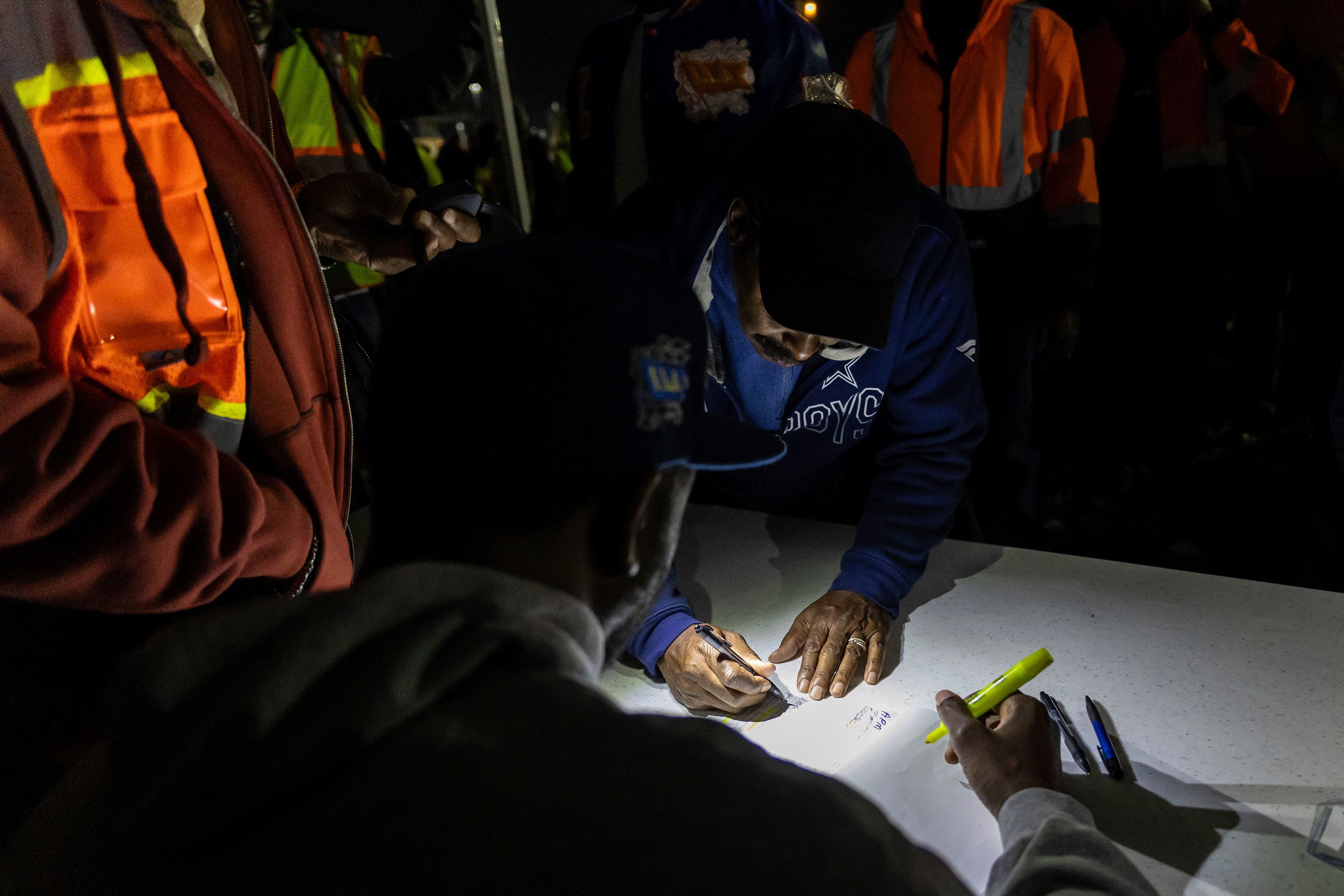 A union worker signs in at the Port Newark-Elizabeth Marine Terminal complex