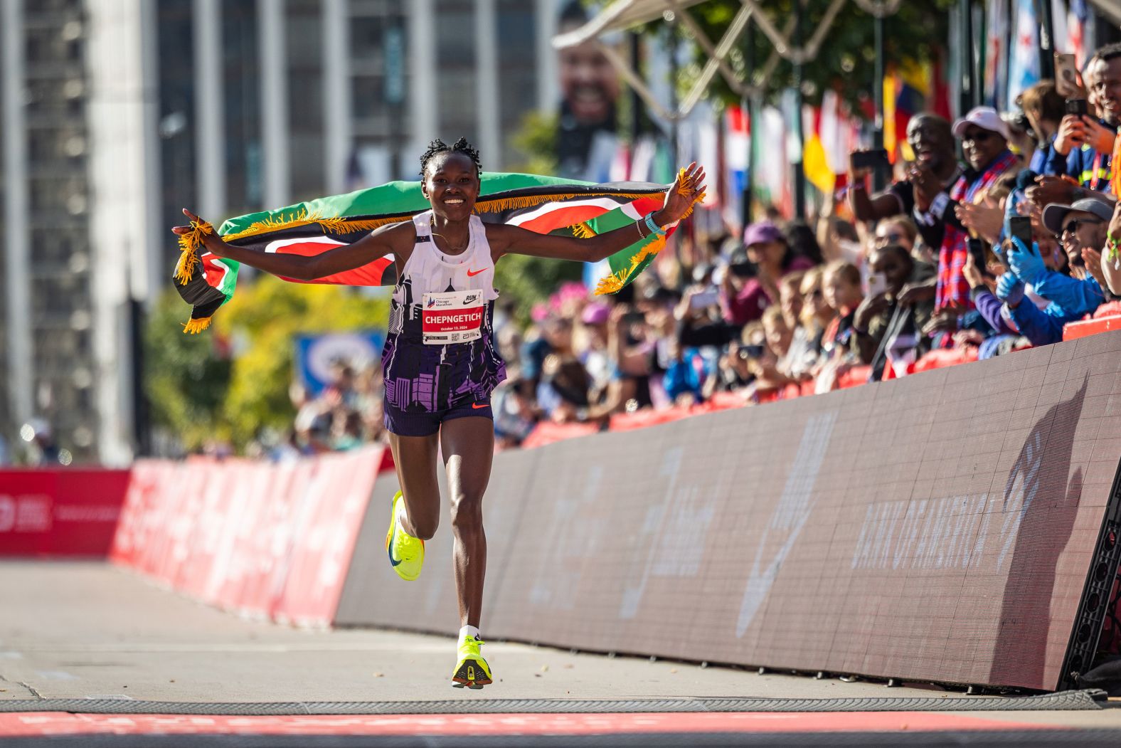 Ruth Chepngetich runs with the Kenyan flag after finishing the Chicago Marathon on Sunday, October 13. <a href="index.php?page=&url=https%3A%2F%2Fwww.cnn.com%2F2024%2F10%2F13%2Fsport%2Fruth-chepngetich-womens-marathon-world-record-chicago-spt-intl%2Findex.html">Chepngetich obliterated the women’s marathon world record</a>, finishing in 2:09:56 — nearly two minutes better than the previous record.
