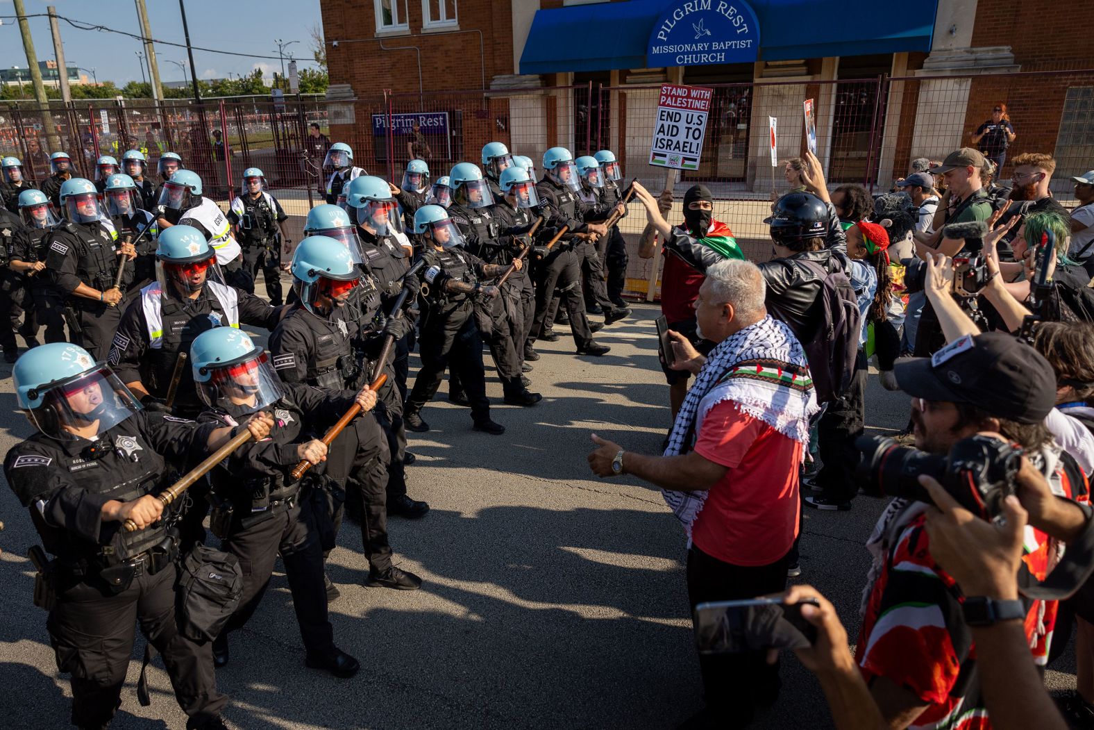 Police in Chicago face pro-Palestinian demonstrators near a perimeter fence outside the Democratic National Convention on Monday, August 19. <a >Thirteen people were arrested</a>?during protests related to the convention on Monday, according to Chicago Police Department Superintendent Larry Snelling. Ten of those arrests stemmed from a small group that?<a >breached</a>?a portion of the northern security perimeter fence at the United Center, he said.