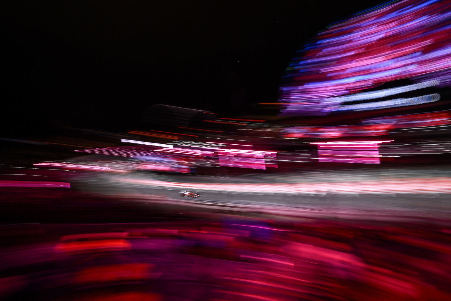 In this photo, taken with a long exposure, Formula One driver Charles Leclerc speeds down the track during a practice lap in Las Vegas on Thursday, November 20.
