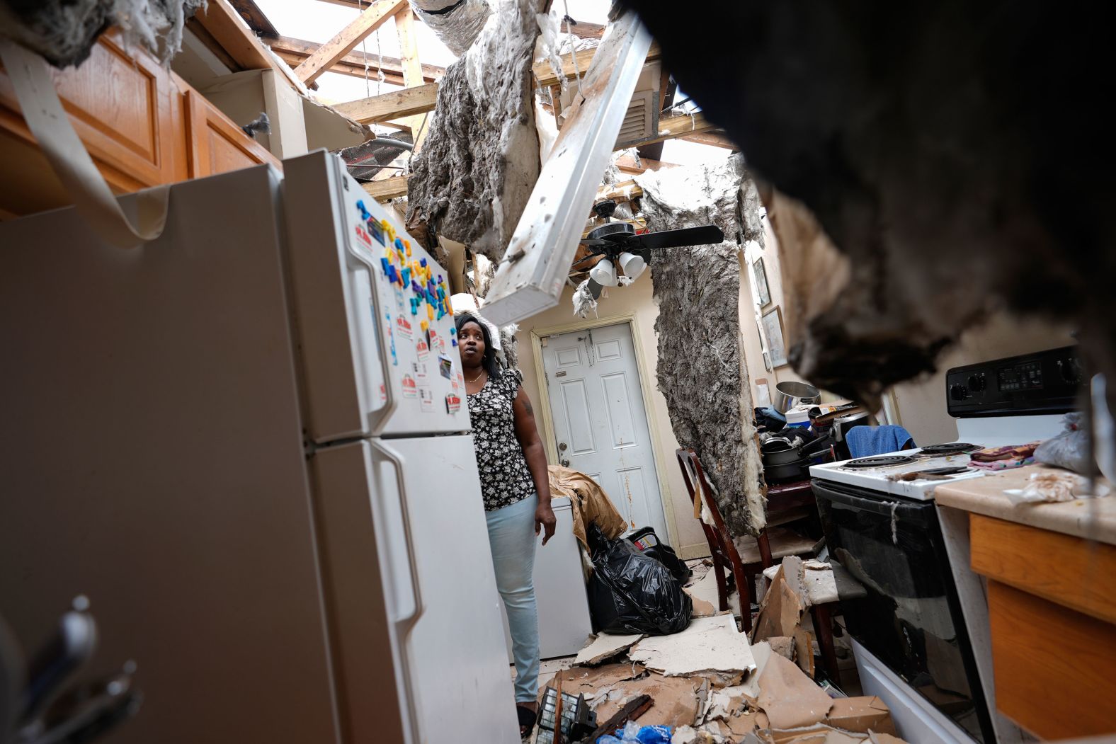 Natasha Ducre surveys the kitchen of her devastated home in Palmetto, Florida, on Thursday, October 10. Ducre, her husband, three children and two grandchildren stayed in a shelter as <a href="https://www.cnn.com/2024/10/08/weather/gallery/hurricane-milton/index.html">Hurricane Milton</a> powered through the state.