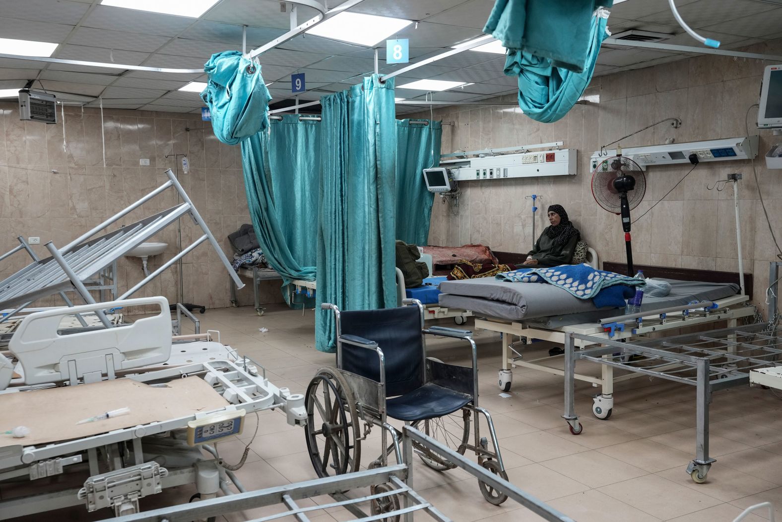 A woman sits on a bed at the Al-Aqsa Martyrs Hospital in Deir al-Balah, Gaza, on Sunday, August 25. <a >Israeli strikes in Gaza</a> have killed more than 40,000 Palestinians and injured more than 90,000, according to the Ministry of Health there. The Israeli military launched its aerial and ground assault in Gaza after Hamas attacked southern Israel on October 7, killing around 1,200 people and abducting more than 250, according to Israeli authorities.