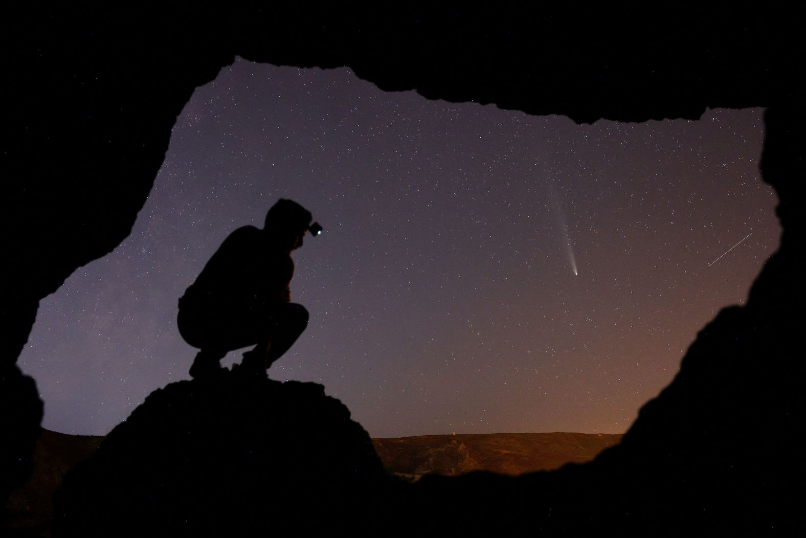 Eduardo Robaina observes a recently discovered comet, <a href="index.php?page=&url=https%3A%2F%2Fwww.cnn.com%2F2024%2F10%2F09%2Fscience%2Fcomet-tsuchinshan-atlas-earth%2Findex.html">known as C/2023 A3 Tsuchinshan–ATLAS</a>, from inside a cave in Temisas, Spain, on Tuesday, October 22.