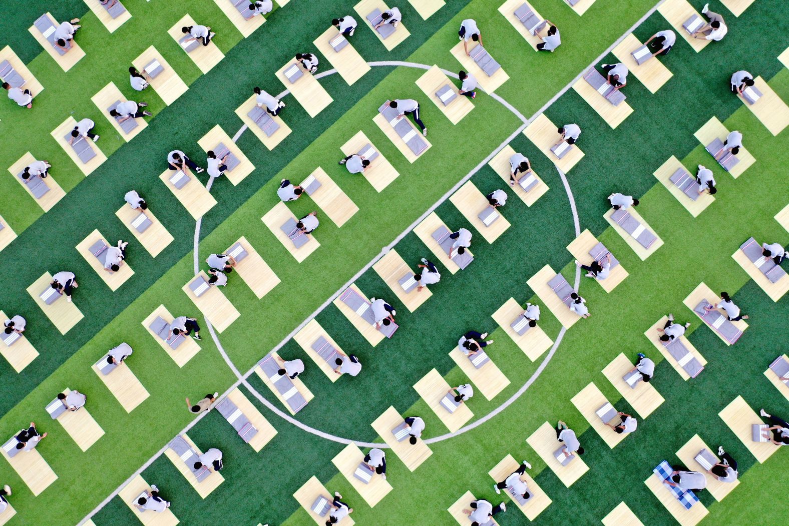 Students take part in a quilt-folding competition during military-style training on a high school sports field in Dongyang, China, on Thursday, August 15.