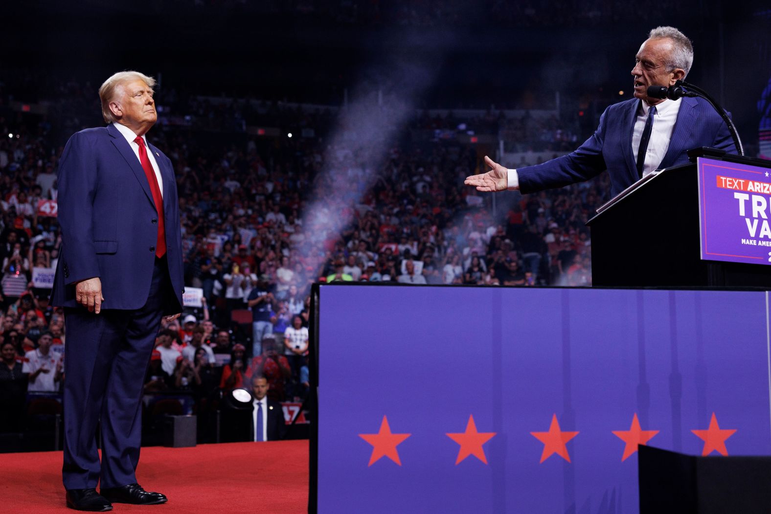 Former President Donald Trump, left, watches Robert F. Kennedy Jr. speak at a campaign rally in Glendale, Arizona, on August 23. Kennedy had just suspended his independent campaign and <a >threw his support behind Trump</a>.