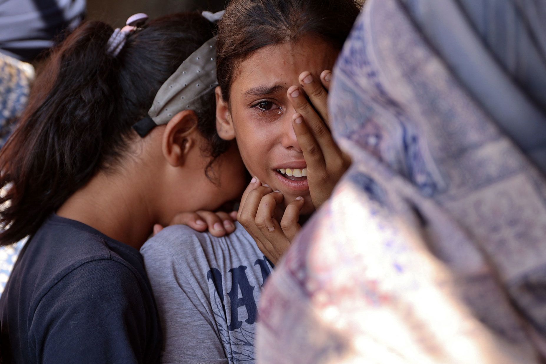 Children react to an Israeli airstrike in Gaza