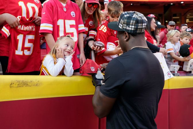 New Orleans Saints linebacker Willie Gay Jr. signs autographs for a young Kansas City Chiefs fan before the start of the game between the teams in Kansas City, Missouri, on Monday, October 7. Gay played for the Chiefs for four seasons before signing with the Saints during the offseason. <a >The Chiefs beat the Saints 26-13</a>.