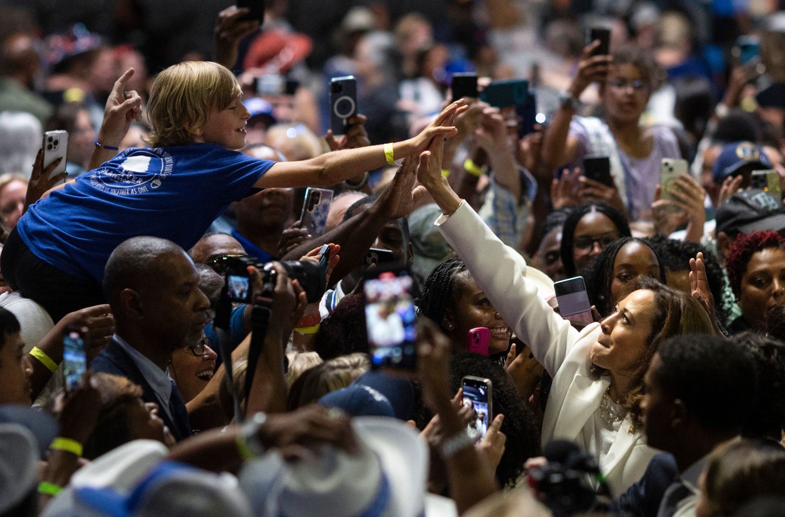 Vice President Kamala Harris high fives attendees at a campaign rally in Savannah, Georgia, on Thursday, August 29.