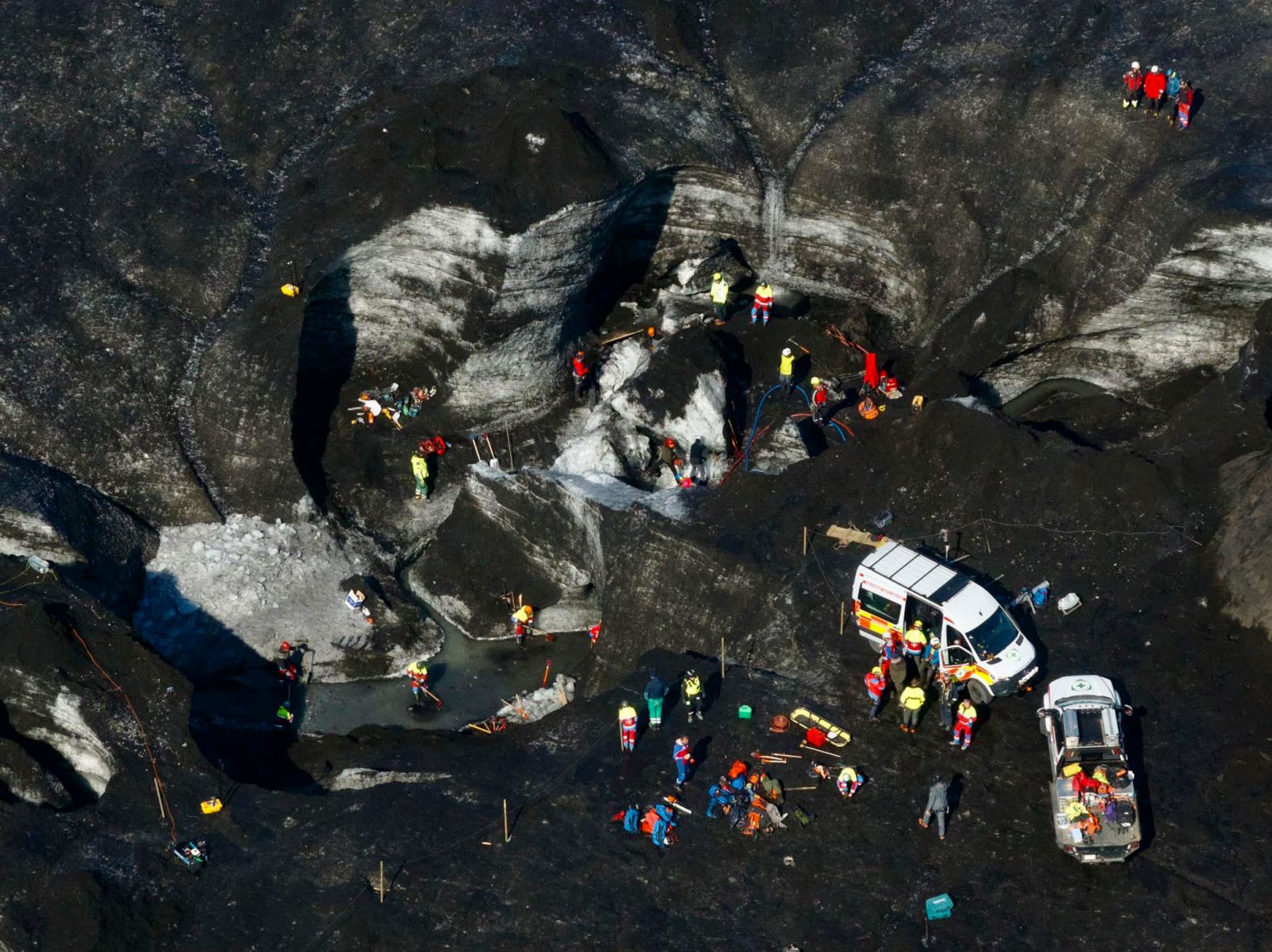 Rescue teams work at the site of a <a >cave collapse in southeastern Iceland</a> on Monday, August 26. One American man was killed in the collapse, and one American woman was injured.