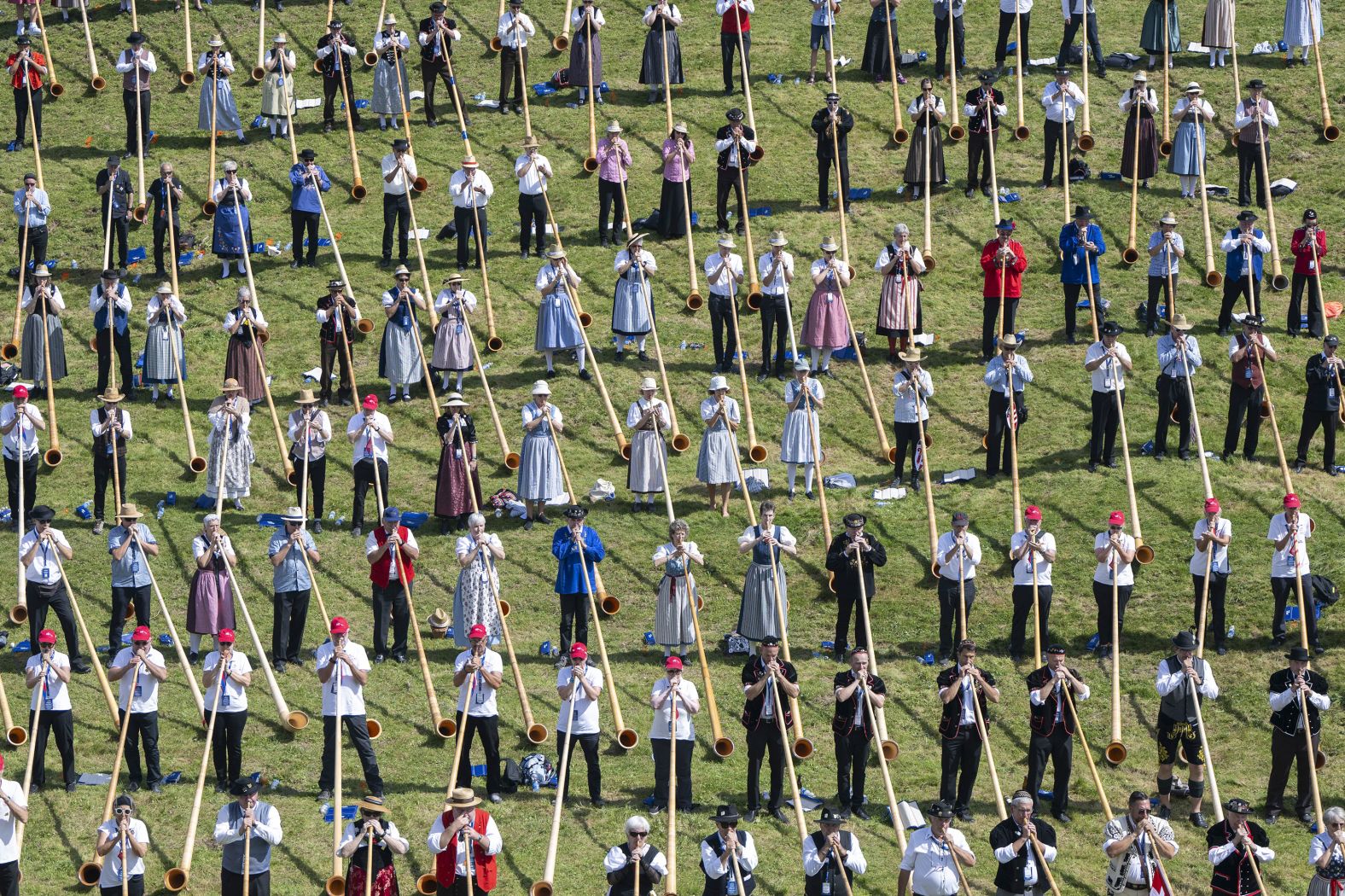 Over 1,000 alphorn players line up to attempt to break the Guinness World Record for the largest alphorn ensemble in Nidwalden, Switzerland, on Saturday, August 31.