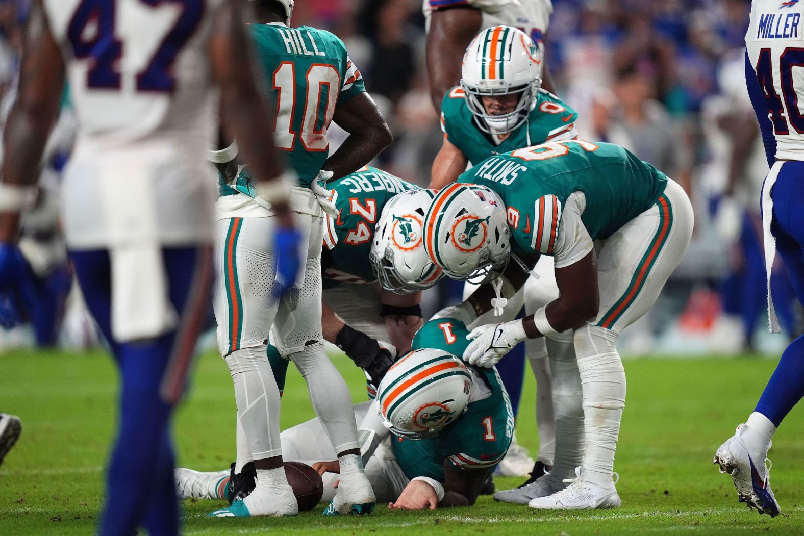 Miami Dolphins players attend to quarterback Tua Tagovailoa after he took a hit to the head in the second half of a game against the Buffalo Bills in Miami Gardens, Florida, on Thursday, September 12. <a >Tagovailoa was later ruled out with a concussion</a>. Tagovailoa has a history of concussions and experienced multiple in the 2022 season. In April 2023, he said he considered walking away from football “for a time” after the concussion issues. <a >See more photos from the 2024 NFL season</a>.