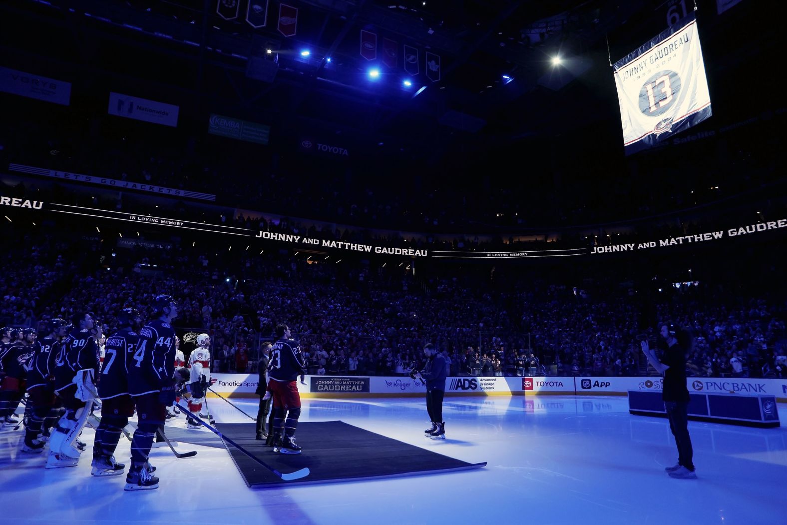 Members of the NHL’s Columbus Blue Jackets and Florida Panthers participate in a <a href="https://www.cnn.com/2024/10/15/sport/blue-jackets-honor-johnny-gaudreau-in-emotional-ceremony-spt-intl/index.html">pregame ceremony</a> as a banner is raised for the late Johnny Gaudreau in Columbus, Ohio, on Tuesday, October 15. Gaudreau, a Blue Jackets star, and his younger brother Matthew were killed in August when they were riding their bicycles and were hit by a suspected drunken driver.