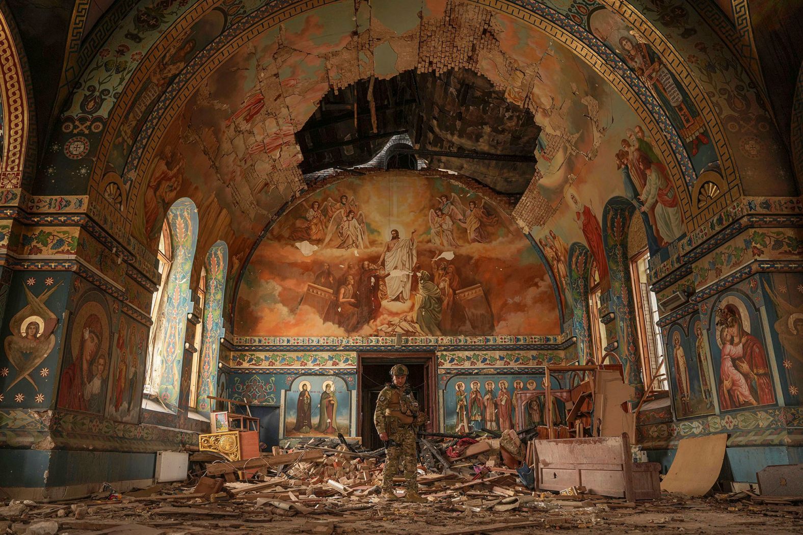 Ukrainian serviceman Gennadiy Yudin stands inside an Orthodox church heavily damaged by a Russian bombing in Novoekonomichne, Ukraine, on Tuesday, September 17.