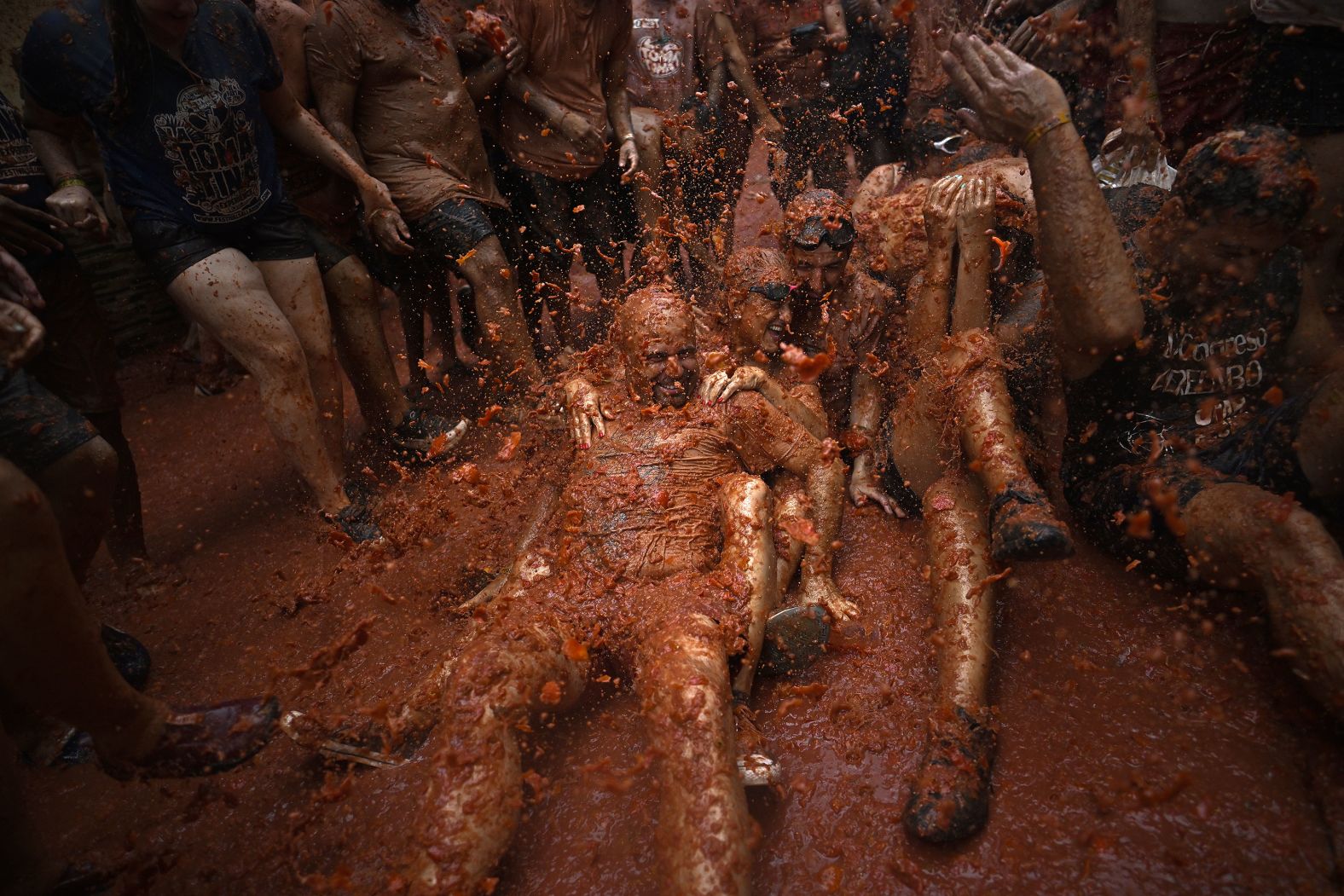 People covered in tomato pulp take part in La Tomatina, an annual festival/food fight in Bu?ol, Spain, on Wednesday, August 28.