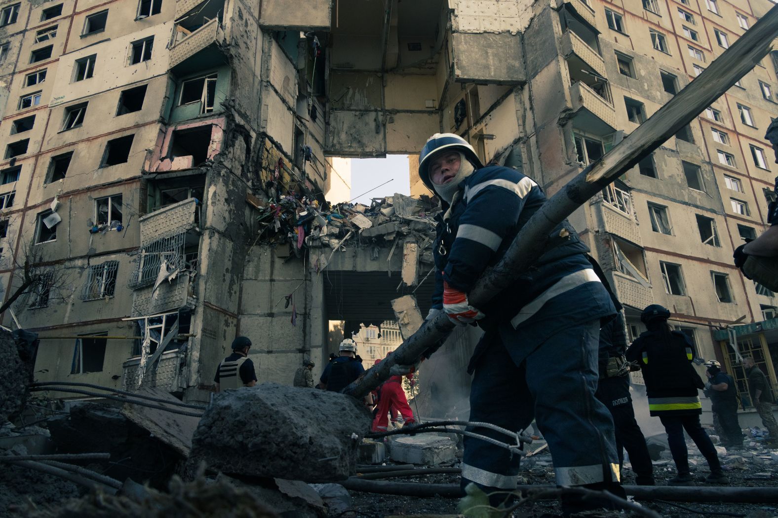Firefighters clear rubble in search of missing people following an air strike in Kharkiv, Ukraine, on Tuesday, September 24.
