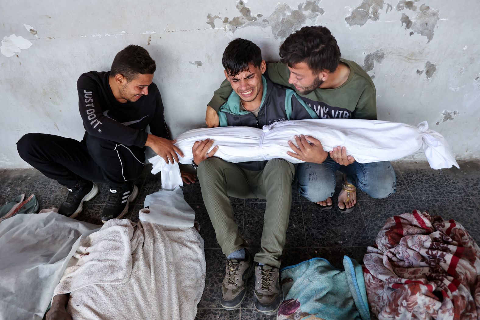 Ali Assaf, center, mourns for his relatives Saturday, October 12, after an overnight Israeli airstrike in the Jabalya refugee camp in northern Gaza. Israel’s military said it also <a href="https://www.cnn.com/2024/10/08/middleeast/gaza-jabalya-idf-shooting-intl/index.html">launched a new ground operation in Jabalya</a> amid efforts by Hamas to “rebuild its operational capabilities in the area.”