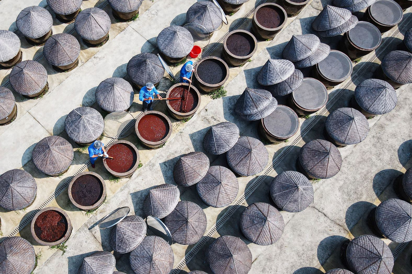 Workers make soy sauce at a village in Rugao, China, on Thursday, August 22.