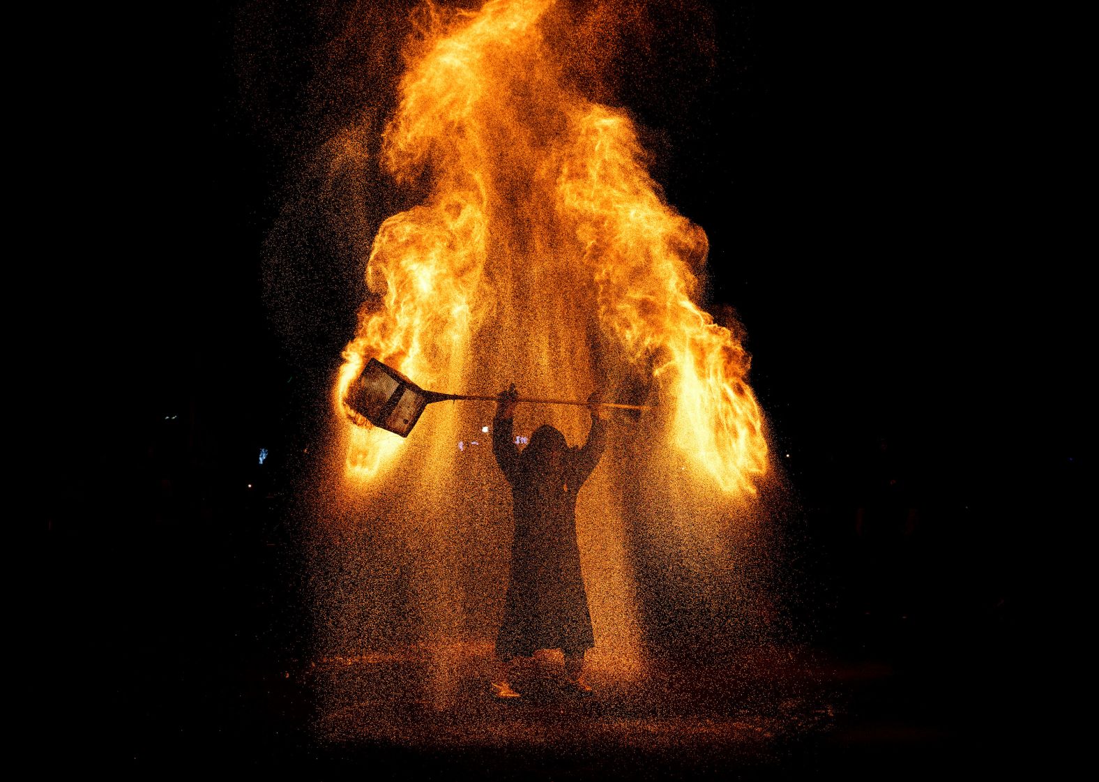 A traditional molten-fire performance takes place at a market in Beijing during the Golden Week holiday on Thursday, October 3.