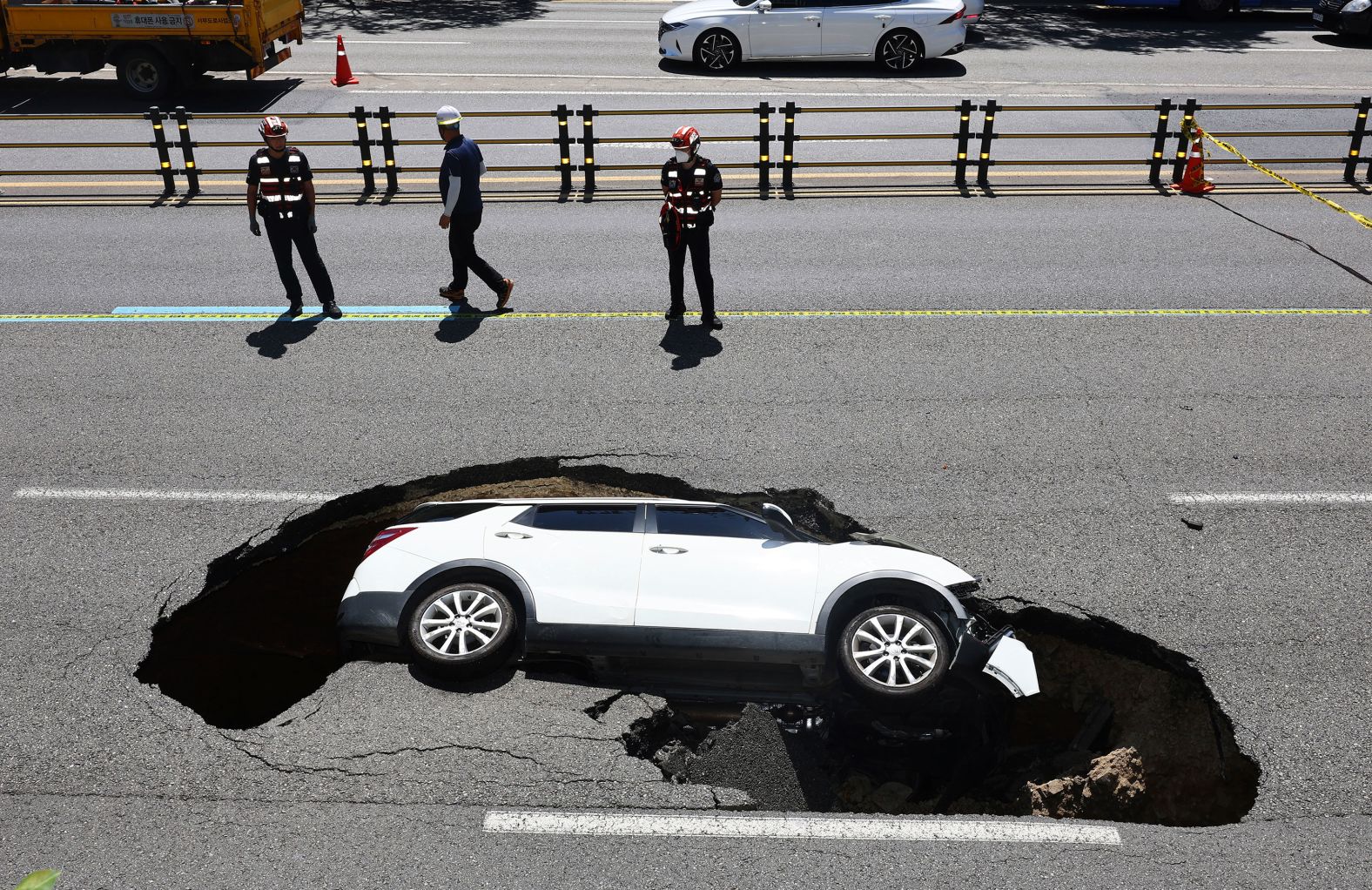 A vehicle is swallowed by a sinkhole in Seoul, South Korea, on Thursday, August 29. Emergency workers rescued the 82-year-old driver and a 76-year-old passenger who were both injured, <a  target="_blank">according to the Associated Press</a>.